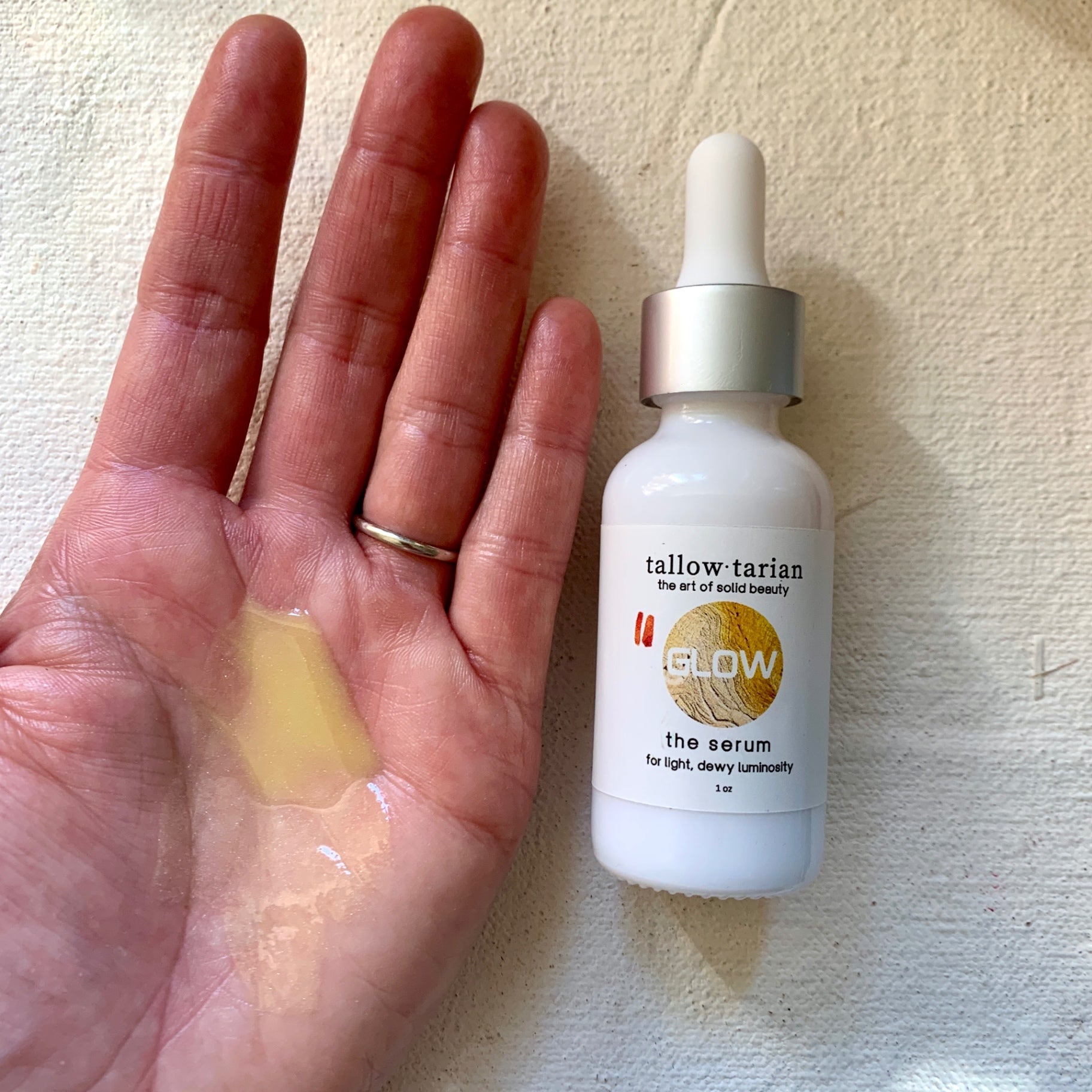 The Over All Glow Serum on palm
