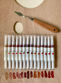 The Manifold Lip Varnish/Brush — full shade range with palette knife and swatches